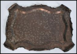 A large early 20th century Arts & Crafts ' Acanthus ' copper tray by Townshend & Co having raised