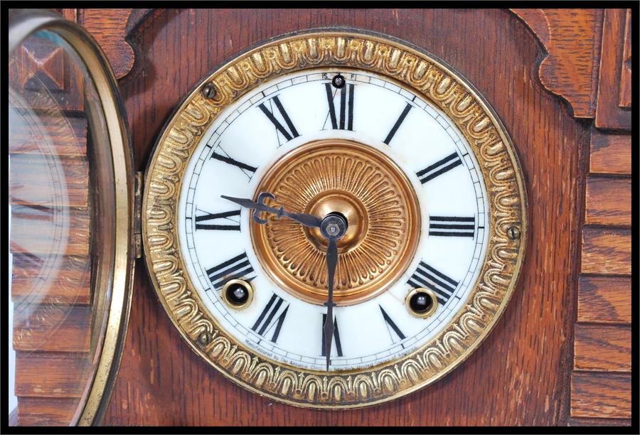 A 19th century American mantel bracket clock having an oak case with gilt dial and white enamel - Image 7 of 19