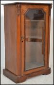 A 19th century Victorian mahogany inlaid pier - pedestal music cabinet having plinth base with glass
