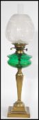 A Victorian brass and green glass oil lamp of neo-classical form having acid etched globe shade