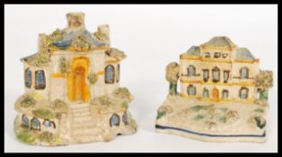 Two early 19th century Staffordshire cottage / house models with hand painted details and textured