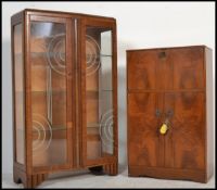 A 1950's walnut cocktail drinks cabinet with articulated top with appointed interior over cupboard