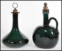 Two late 19th century/ early 20th century green coloured glass claret decanters with silver plated