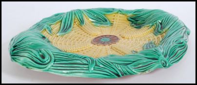 A 19th century Victorian Majolica ceramic bread board plate depicting corn in a woven basket.