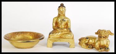 A selection of gilt bronze/ metal Chinese desk items to include an embossed prayer bowl with