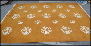 A very large 20th Century floor rug in the Chinese style, the rug on a light green ground with