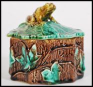 A 19th century Victorian Majolica pot in the form of a log with leaf and vine decoration having a