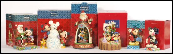 A selection of of Disney Showcase Christmas related figurines to include 'Modern Day Mickey'