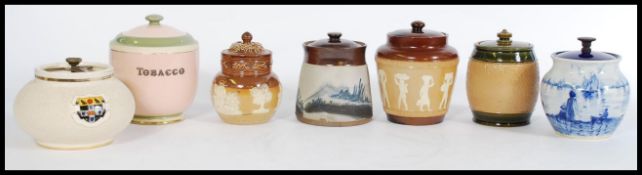 A collection of vintage 20th century tobacco jars to include a Carlton ware pink tobacco jar reading