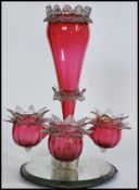 A 19th century Victorian cranberry ruby vaseline glass epergne centrepiece with central trumpet