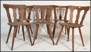 A set of six early 20th Century splat back dining chairs, elm seat pads shaped splat backs raised on