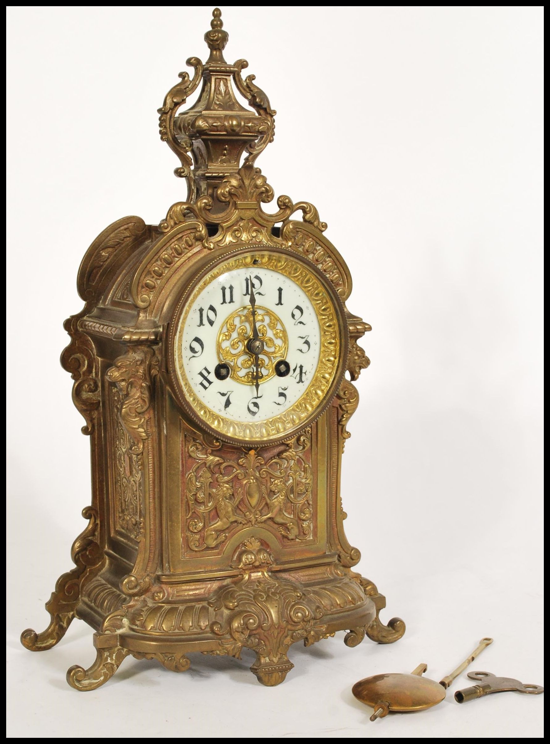 A 19th Century French gilt metal eight day mantel clock striking on a bell, the case ornately cast
