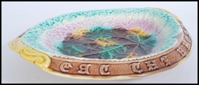 A 19th century Victorian Majolica bread board plate of typical form with notation to sides reading