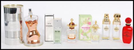 A collection of perfume bottles to include Jean Paul Gaultier, Chanel, Vivienne Westwood x2,