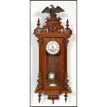 A 20th century Vienna regulated pendulum wall clock of mahogany, with an enamelled face with roman