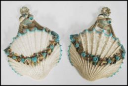 A pair of 19th century majolica wall pockets in the form of scallop shells with blue foliate