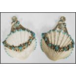 A pair of 19th century majolica wall pockets in the form of scallop shells with blue foliate