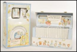 A group of 20th century Beatrix potter items to include a book set and a Wedgwood ceramic set.