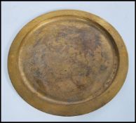 A vintage Tiffany Studios gilded bronze charger tray of circular form having raised edge. Stamped