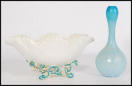 A 19th Century Victorian porcelain flower centrepiece, raised on scroll supports. Having turquoise