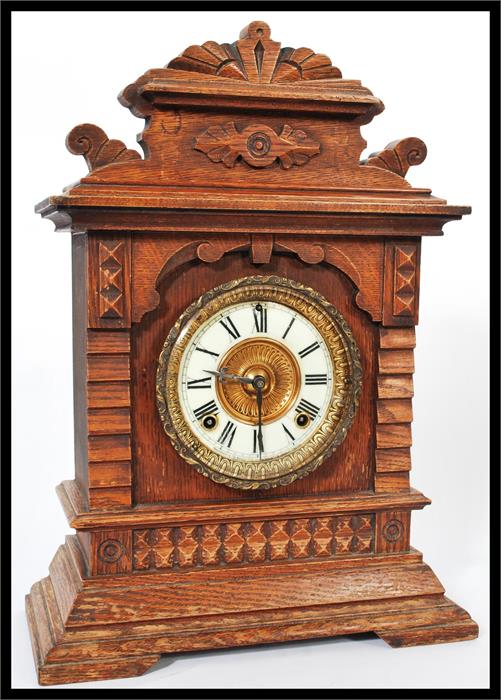 A 19th century American mantel bracket clock having an oak case with gilt dial and white enamel - Image 2 of 19