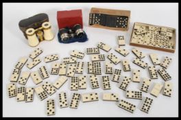 A selection of assorted dominoes to include an early 20th century ebony and bone set, a set of mid