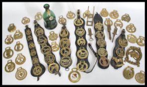 A collection of horse brasses of various designs dating from the 19th Century to include examples on