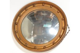 A Regency style gilt circular convex wall mirror,