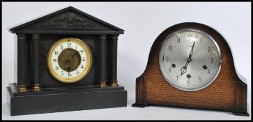 A late Victorian black slate mantel clock of architectural form together with a 1930's Art Deco