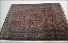 A vintage early 20th Century Middle Eastern woven floor rug on black and red ground, geometric