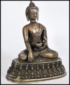 A bronze / brass  hollow cast Chinese figurine of a Deity raised on a plinth with detailed edges,
