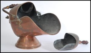 A Victorian 19th century copper coal scuttle and shovel. The scuttle on circular plinth with