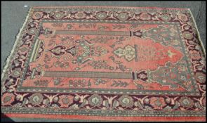 A large early 20th century Persian - Islamic prayer rug with red ground, central large Mihrab and