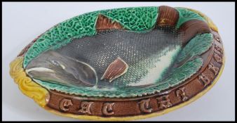 A 19th century Victorian Majolica bread board plate depicting a fish with notation to sides