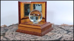 A 20th century gypsy fortune tellers crystal ball in wooden case together with a wooden glass plinth