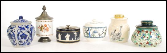 A selection of vintage tobacco jars to include a lustre jar with a pelican design to the side and