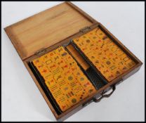 A set of early 20th century Mahjong game bakelite / lucite tiles bearing character marks and