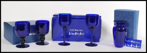 A collection of boxed Bristol Blue glass wares to include a large pair of goblets, smaller pair of