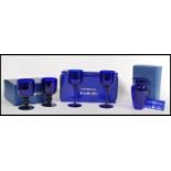 A collection of boxed Bristol Blue glass wares to include a large pair of goblets, smaller pair of