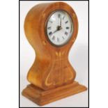 A late 19th Century / early 20th Century satinwood Art Nouveau inlaid mantel clock, decorated with