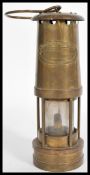 E. Thomas & Williams Ltd copper and brass miners lamp with carry loop to the top. Measures 24cm-high