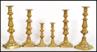 A large pair of 19th century Victorian brass candlesticks with single sconces together with a