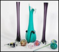 A selection of 20th century glass wares to include two tall purple coloured glass vases with four