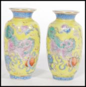 A pair of 19th century Canton Enamel Chinese miniature vases having a famille Juan ground with