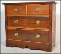 An Edwardian walnut cottage chest of drawers being raised on a shaped plinth base with 2 short and 2