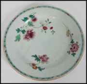 An 18th century Chinese porcelain plate hand enameled with floral sprays and painted turquoise