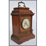 A 19th century HAC oak cased mantel clock having decorative oak case inset brass movement stiking on