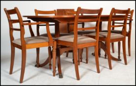 A Regency revival mahogany twin pillar extendable dining table, on moulded splayed supports with