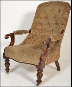 A Victorian 19th century mahogany library armchair being raised on turned legs with castors,