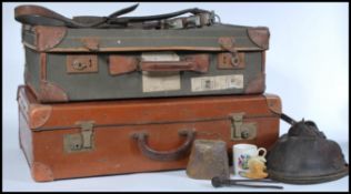 Two vintage 20th Century leather suitcases, one leather and the other canvas together with a